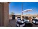 Stylishly staged backyard with a dining area, lounge seating, and outdoor cooking space at 29109 N Fire Agate Rd, San Tan Valley, AZ 85143