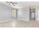 Bright bedroom featuring light wood floors, neutral paint, ceiling fan, and window for ample light at 29109 N Fire Agate Rd, San Tan Valley, AZ 85143