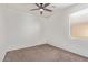 Bedroom with ceiling fan, window and neutral carpet at 29109 N Fire Agate Rd, San Tan Valley, AZ 85143