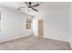 Bright bedroom featuring neutral carpet, natural light, and a ceiling fan for added comfort at 29109 N Fire Agate Rd, San Tan Valley, AZ 85143