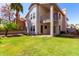 Backyard featuring a lush green lawn and a two-story home with a balcony at 3165 W Golden Ln, Chandler, AZ 85226