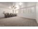 Spacious recreation room with carpet, bar, and plenty of natural light from large windows at 3165 W Golden Ln, Chandler, AZ 85226