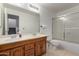 Large bathroom features a double sink vanity and a shower/tub with glass doors at 3165 W Golden Ln, Chandler, AZ 85226