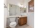Modest bathroom features a wood vanity, a large mirror, a toilet, and tile flooring at 3165 W Golden Ln, Chandler, AZ 85226