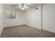 Neutral carpeted bedroom featuring a ceiling fan and bright natural light at 3165 W Golden Ln, Chandler, AZ 85226