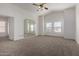 Spacious bedroom with neutral carpet, large windows, and plenty of natural light at 3165 W Golden Ln, Chandler, AZ 85226
