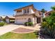 Charming two-story home with a manicured lawn, a two-car garage, and attractive desert landscaping at 3165 W Golden Ln, Chandler, AZ 85226