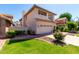 View of a two-story home, showing landscaping, a tiled roof and an attached two-car garage at 3165 W Golden Ln, Chandler, AZ 85226