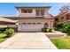 Charming two-story home showcasing a well-manicured lawn, tiled roof, and attached two-car garage at 3165 W Golden Ln, Chandler, AZ 85226