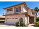 View of a two-story home with a tiled roof, manicured landscaping and an attached two-car garage at 3165 W Golden Ln, Chandler, AZ 85226