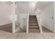 Hallway showcasing the carpeted stairs leading to the upper level, complemented by neutral walls and tile floors at 3165 W Golden Ln, Chandler, AZ 85226