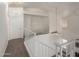 Bright, carpeted hallway with white banister and a hanging ceiling fan at 3165 W Golden Ln, Chandler, AZ 85226