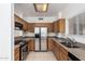 Well-equipped kitchen with stainless steel appliances and wood cabinets at 3165 W Golden Ln, Chandler, AZ 85226