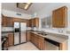Functional kitchen with stainless steel appliances, oak cabinets, and ample countertop space at 3165 W Golden Ln, Chandler, AZ 85226