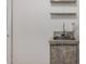 The laundry area features a utility sink with marble countertops and shelving on the wall at 3165 W Golden Ln, Chandler, AZ 85226