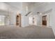 Bright living room features a staircase, neutral carpet, a large window and access to adjacent rooms at 3165 W Golden Ln, Chandler, AZ 85226