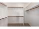 Large walk-in closet with wood shelving and racks providing ample storage space at 3165 W Golden Ln, Chandler, AZ 85226