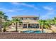 Expansive backyard featuring a sparkling pool, mature palm trees, and a covered patio at 3169 E Eleana Ln, Gilbert, AZ 85298