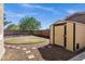 The backyard features a shed, grass area, gravel, and a concrete pathway leading to the shed at 3169 E Eleana Ln, Gilbert, AZ 85298