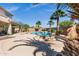 An entertainer's backyard, featuring a firepit, mature landscaping, a pool, and a covered patio at 3169 E Eleana Ln, Gilbert, AZ 85298