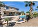 The backyard has a pool with a firepit, mature landscaping, and a covered patio at 3169 E Eleana Ln, Gilbert, AZ 85298
