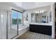 Luxurious bathroom with a separate shower, bathtub, and a large window offering natural light at 3169 E Eleana Ln, Gilbert, AZ 85298