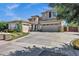 Stunning home boasts a large driveway, desert landscaping, and a two-car plus one-car garage at 3169 E Eleana Ln, Gilbert, AZ 85298