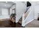Elegant foyer with hardwood floors, a wooden staircase, and a decorative table with a mirror at 3169 E Eleana Ln, Gilbert, AZ 85298