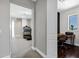 Hallway view leading to a home office and a fitness room with a treadmill at 3169 E Eleana Ln, Gilbert, AZ 85298
