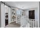 Bright hallway featuring built-in shelves, plush carpet, and a white railing overlooking the staircase at 3169 E Eleana Ln, Gilbert, AZ 85298