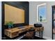 Home office featuring black accent wall, wood desk, comfortable chair, and natural light at 3169 E Eleana Ln, Gilbert, AZ 85298