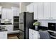Gourmet kitchen with stainless steel appliances, white cabinets, and a built-in workstation at 3169 E Eleana Ln, Gilbert, AZ 85298