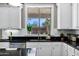 Kitchen features a view of the backyard, white cabinets and a stainless steel dishwasher at 3169 E Eleana Ln, Gilbert, AZ 85298