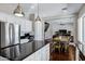 Open concept kitchen has a stainless steel refrigerator, island with seating, and dining area at 3169 E Eleana Ln, Gilbert, AZ 85298