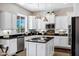 Bright kitchen with white cabinets, dark countertops, stainless steel appliances, and natural light at 3169 E Eleana Ln, Gilbert, AZ 85298