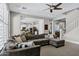 Spacious living room with a large sectional sofa, ceiling fan, and views into the modern, eat-in kitchen at 3169 E Eleana Ln, Gilbert, AZ 85298