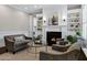 Cozy living room features a fireplace with built-in shelving and plenty of seating at 3169 E Eleana Ln, Gilbert, AZ 85298