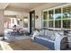 This cozy covered patio area has comfortable seating, a grill, and a dining table at 3169 E Eleana Ln, Gilbert, AZ 85298