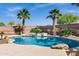 The resort-style pool area has mature landscaping, boulders, and a raised waterfall feature at 3169 E Eleana Ln, Gilbert, AZ 85298