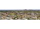 An aerial view showcasing a neighborhood with mature trees and a mountain backdrop at 3736 W Angela Dr, Glendale, AZ 85308
