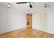 Bedroom featuring hardwood floors, a ceiling fan and a closet with mirrored doors at 3736 W Angela Dr, Glendale, AZ 85308