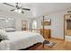 Bright bedroom features a traditional four-poster bed, hardwood floors, and natural light at 3736 W Angela Dr, Glendale, AZ 85308
