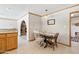 Inviting dining area with view of stone fireplace and easy access to the kitchen at 3736 W Angela Dr, Glendale, AZ 85308