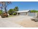 Attractive single-story home with a brick facade, a large driveway, and mature landscaping at 3736 W Angela Dr, Glendale, AZ 85308