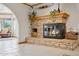 Living area with rustic stone fireplace, wood storage and unique mantle decor at 3736 W Angela Dr, Glendale, AZ 85308
