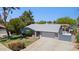 Inviting single-Gathering home with a two-car garage, lush front lawn, and mature trees at 3736 W Angela Dr, Glendale, AZ 85308