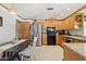 Well-lit kitchen featuring wooden cabinets, stainless steel appliances and a cozy dining area at 3736 W Angela Dr, Glendale, AZ 85308