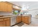 Well-lit kitchen with wood cabinets, granite counters, and stainless steel appliances at 3736 W Angela Dr, Glendale, AZ 85308
