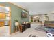 Inviting living room with stone fireplace, green accent wall, and kitchen access at 3736 W Angela Dr, Glendale, AZ 85308
