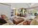 Spacious living room featuring tile floors, comfortable seating, and a view of the bar at 3736 W Angela Dr, Glendale, AZ 85308